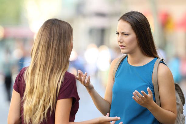 two-angry-women-friends-talking-seriously-on-the-street